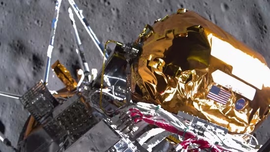 The image depicts the Lunar Reconnaissance Orbiter (LRO) spacecraft, which is a NASA mission designed to study the Moon's surface and composition. The LRO was launched on June 18, 2009, and entered into lunar orbit in August 2009. * **Spacecraft** * The LRO spacecraft is shown with its solar panels extended. * It has a rectangular shape with a flat top and bottom. * The spacecraft is covered in gold-colored insulation material. * There are several antennas protruding from the sides of the spacecraft. * **Background** * The background of the image shows the surface of the Moon, which appears to be rocky and barren. * The surface is dotted with craters and other geological features. The image provides a clear view of the LRO spacecraft in lunar orbit, highlighting its design and functionality. The background of the image shows the rugged terrain of the Moon's surface, providing context for the spacecraft's mission to study this environment.