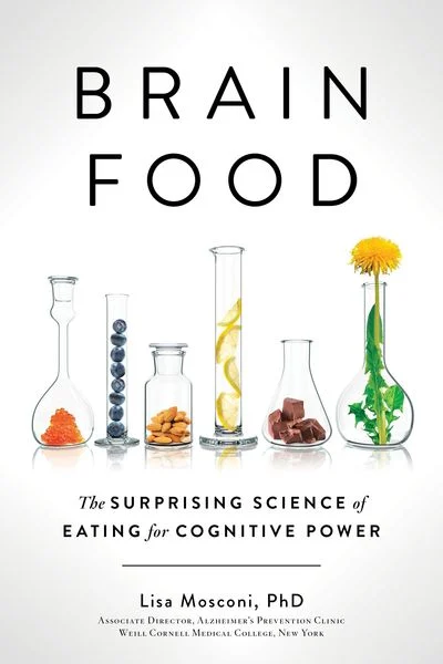 The image is the cover of the book "BRAIN FOOD: The Surprising Science of Eating for Cognitive Power" by Lisa Mosconi, PhD. * A beaker with orange powder in it: + The beaker is clear glass. + It has a wide mouth and a narrow neck. + There is a small amount of orange powder at the bottom of the beaker. * A tall thin cylinder filled with blue balls: + The cylinder is made of transparent plastic or glass. + It has a smooth, rounded shape. + The blue balls are uniform in size and color. * A tall thin tube with yellow slices inside: + The tube is clear glass or plastic. + It has a long, slender shape. + There are several yellow slices floating inside the tube. The image suggests that the book explores the relationship between food and cognitive function, highlighting the importance of certain nutrients and ingredients in supporting brain health.