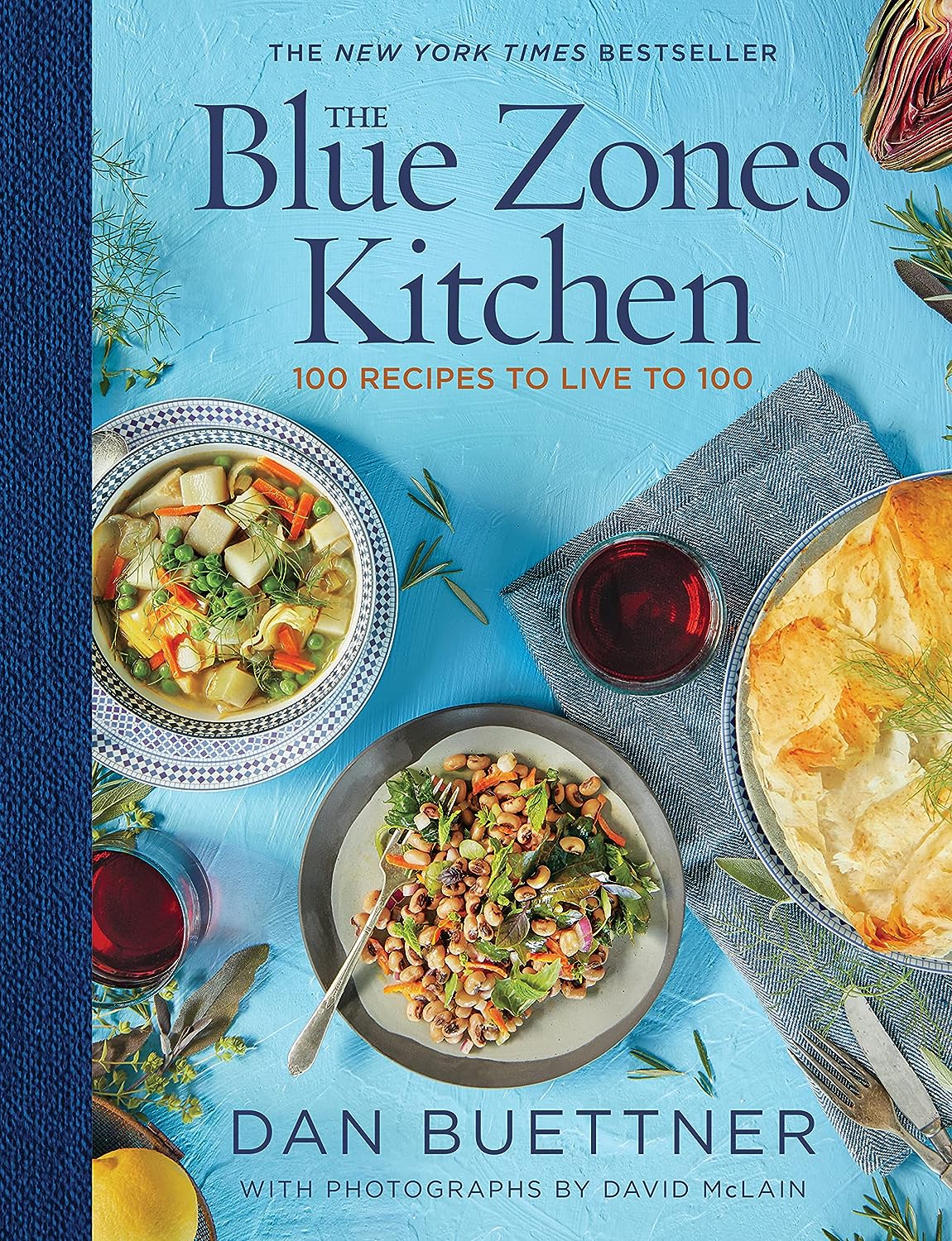 Alt tag: "Cover of 'The Blue Zones Kitchen' by Dan Buettner, featuring vibrant dishes, a blue background, and the text '100 Recipes to Live to 100'."