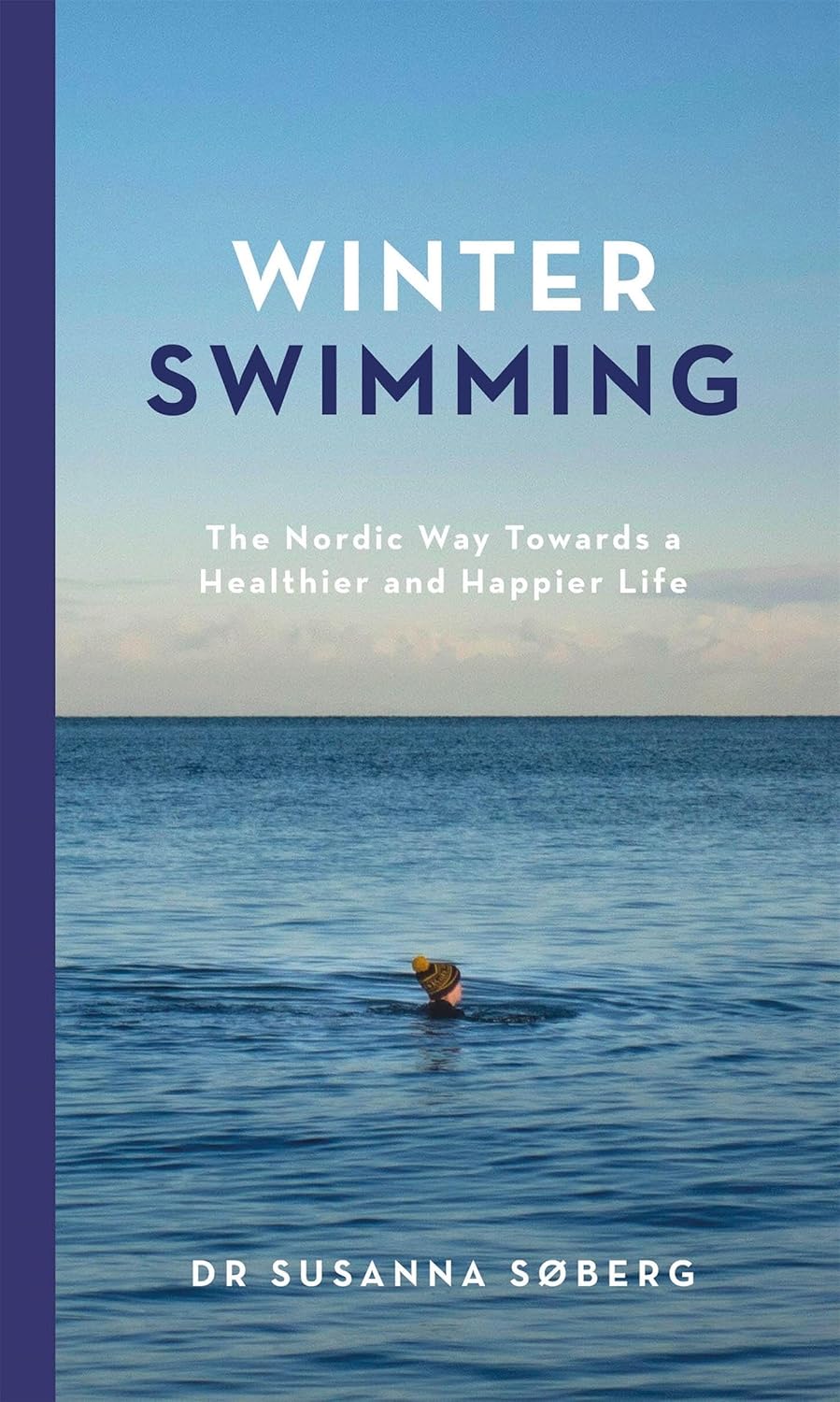 The image is the cover of a book titled "Winter Swimming: The Nordic Way Towards a Healthier and Happier Life" by Dr. Susanna Söberg. * A person swimming in the water: + The person is wearing a yellow hat. + They are floating on their back, with their arms at their sides. + The water appears to be calm and peaceful. * The title of the book "Winter Swimming": + The title is written in large, bold font. + It is centered at the top of the cover. + The words "The Nordic Way Towards a Healthier and Happier Life" are written in smaller text underneath the title. * A person's name, Dr. Susanna Söberg: + The author's name is written in small text at the bottom of the cover. + It is accompanied by a subtitle that reads "Author". Overall, the image suggests that the book is about the benefits of winter swimming and how it can improve one's health and happiness. The use of a peaceful and serene background image, along with the title and author's name, creates a sense of calmness and tranquility, which may appeal to readers who are interested in learning more about this topic.