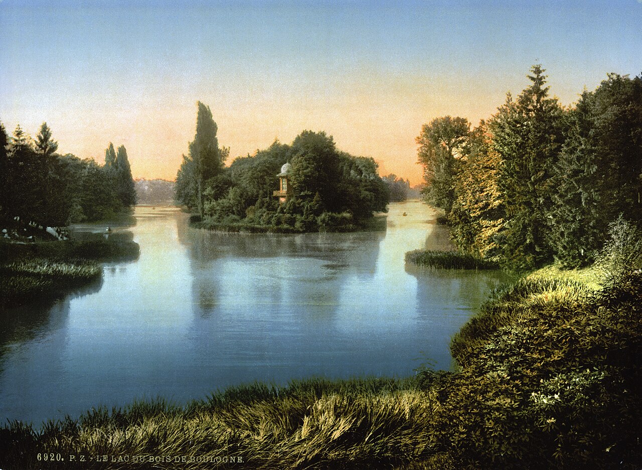 A tranquil landscape depicting a serene lake surrounded by lush greenery and trees at sunset, with a small island featuring a structure in the distance.